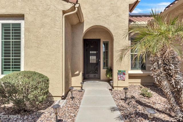 property entrance with stucco siding