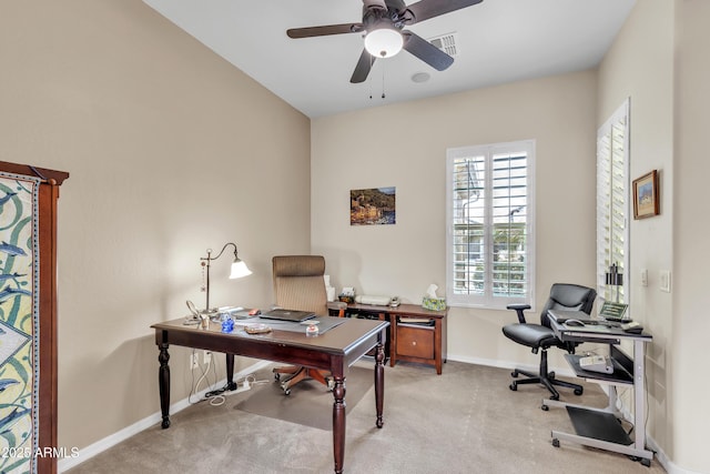 carpeted home office featuring baseboards, visible vents, and ceiling fan