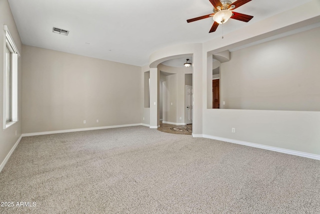 empty room with carpet flooring, ceiling fan, and a healthy amount of sunlight