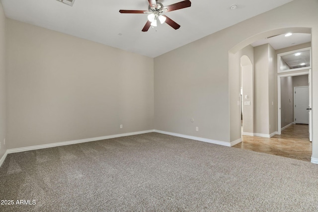 spare room featuring light carpet and ceiling fan