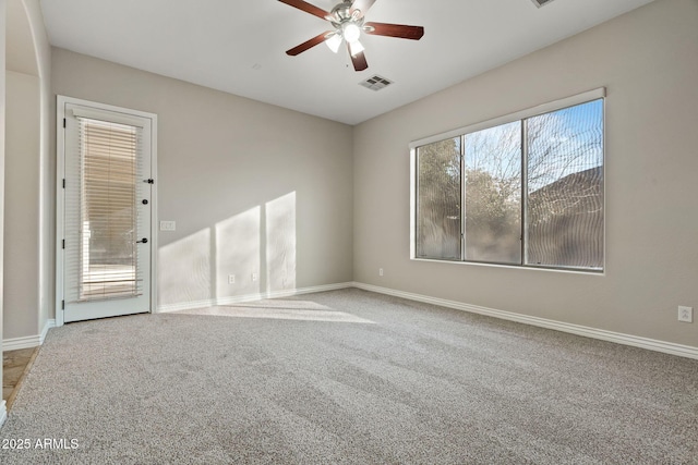 spare room featuring ceiling fan, carpet, and a healthy amount of sunlight