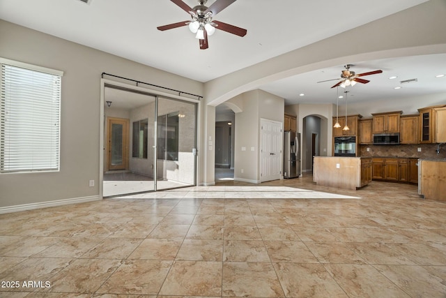 unfurnished living room featuring ceiling fan