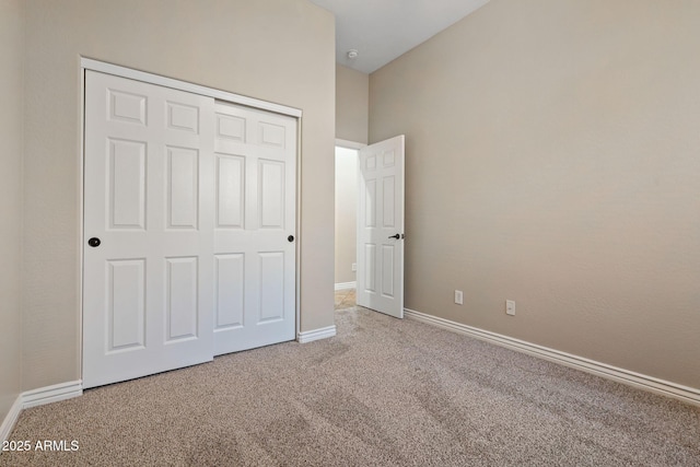 unfurnished bedroom with carpet flooring and a closet