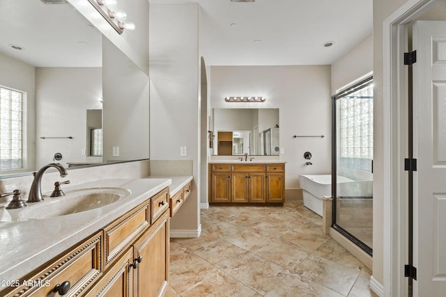 bathroom featuring tile patterned flooring, shower with separate bathtub, vanity, and a wealth of natural light