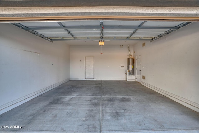 garage with gas water heater and a garage door opener