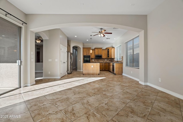 kitchen with backsplash, ceiling fan, sink, black appliances, and lofted ceiling