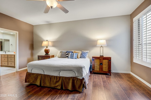 bedroom featuring wood-type flooring, baseboards, and connected bathroom