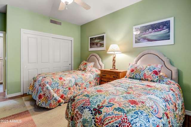 bedroom with a closet, a ceiling fan, and baseboards