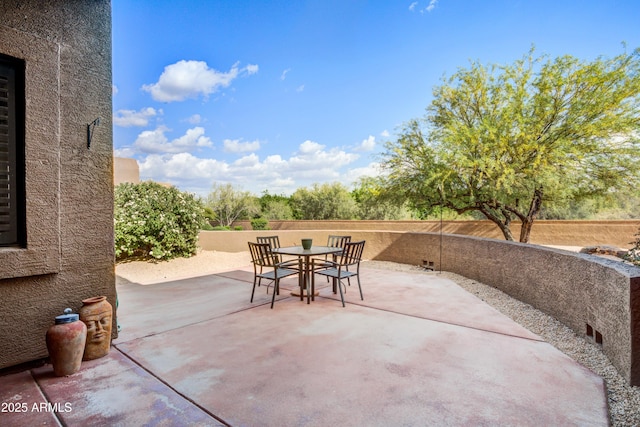 view of patio / terrace with outdoor dining space and fence
