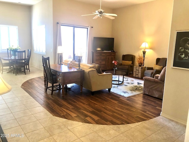 living room with wood finished floors and a ceiling fan