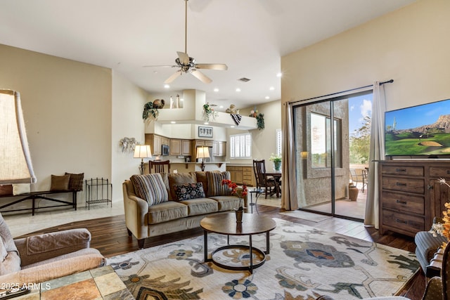 living area with light wood-type flooring and a ceiling fan