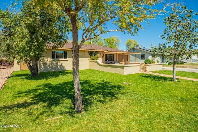 single story home featuring a front yard and fence