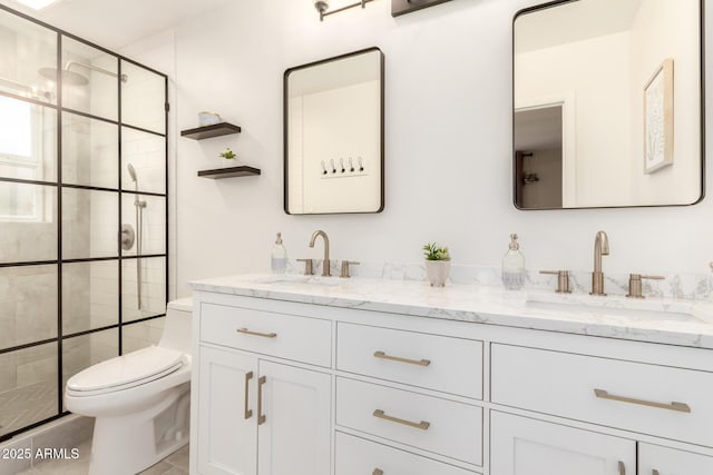 bathroom with a stall shower, double vanity, toilet, and a sink