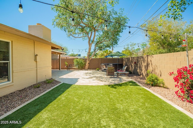 view of yard with a fenced backyard and a patio