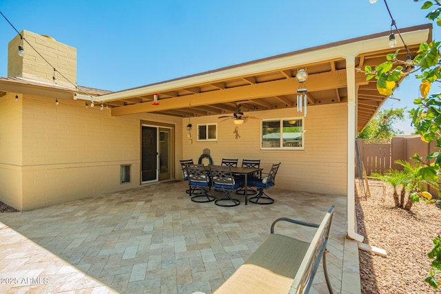 view of patio / terrace with fence, outdoor dining area, and a ceiling fan