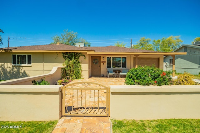 single story home featuring a gate, a fenced front yard, and roof with shingles