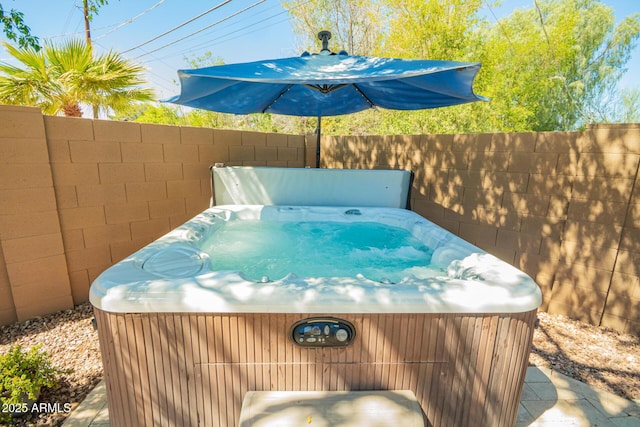 exterior space with a jacuzzi and fence