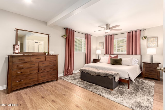 bedroom featuring light wood finished floors, baseboards, beamed ceiling, and ceiling fan