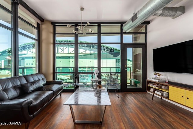 living room with plenty of natural light, dark hardwood / wood-style floors, and expansive windows