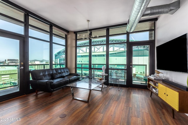 living room with dark hardwood / wood-style flooring and expansive windows