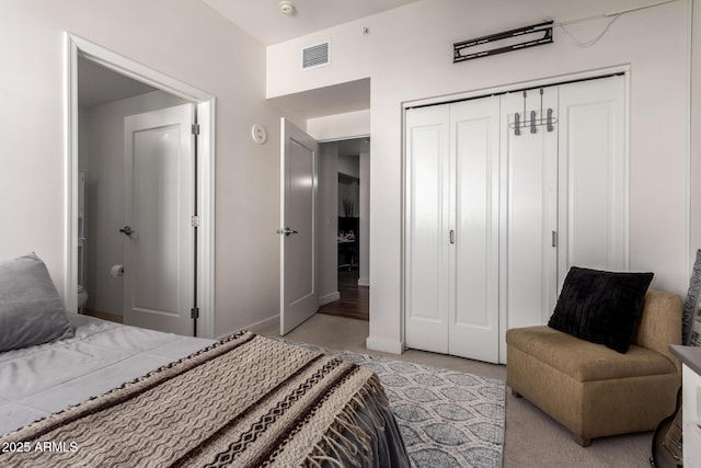 bedroom featuring light colored carpet and a closet