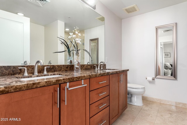 bathroom featuring toilet and vanity