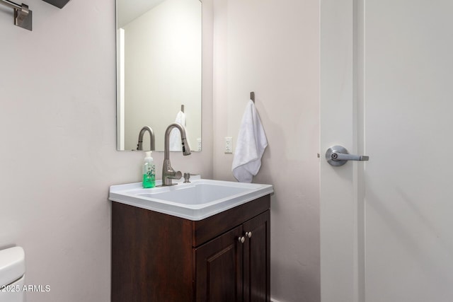 bathroom with toilet and vanity