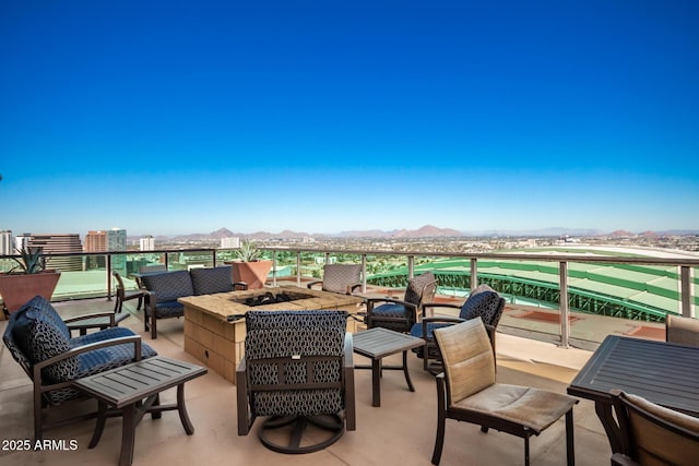 view of patio / terrace with an outdoor living space with a fire pit