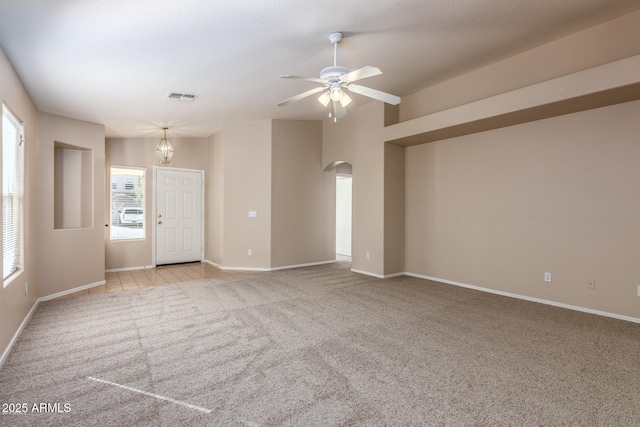 carpeted empty room with ceiling fan and vaulted ceiling