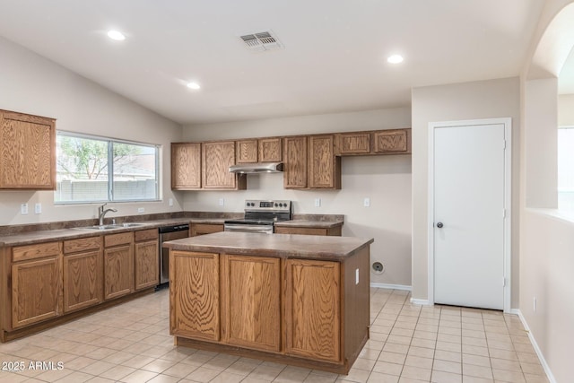 kitchen with stainless steel appliances, sink, a center island, lofted ceiling, and light tile patterned floors