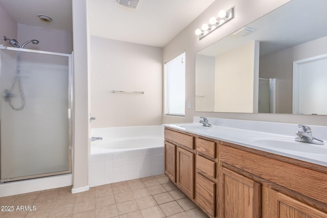 bathroom featuring tile patterned floors, independent shower and bath, and vanity