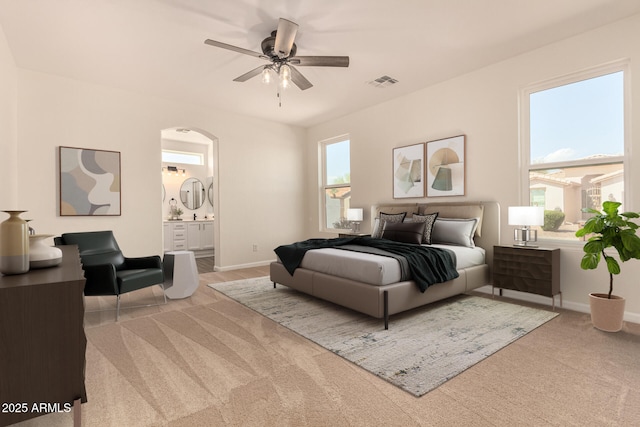 bedroom featuring carpet flooring, ensuite bath, visible vents, and baseboards