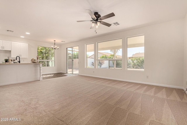 unfurnished living room with recessed lighting, visible vents, light carpet, and baseboards