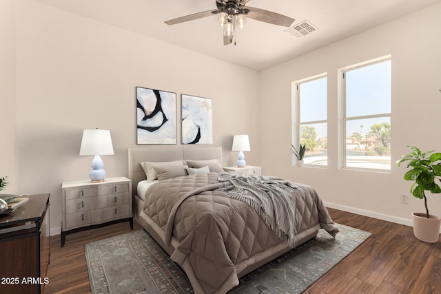 bedroom featuring dark wood-style floors, baseboards, and visible vents