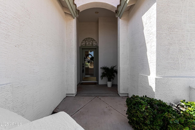 entrance to property featuring stucco siding