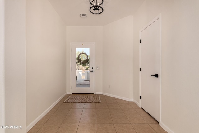 doorway featuring visible vents, baseboards, and light tile patterned floors