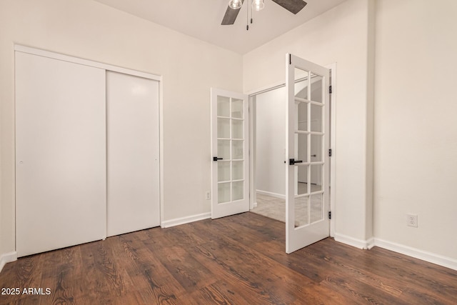 unfurnished bedroom with a closet, wood finished floors, and french doors