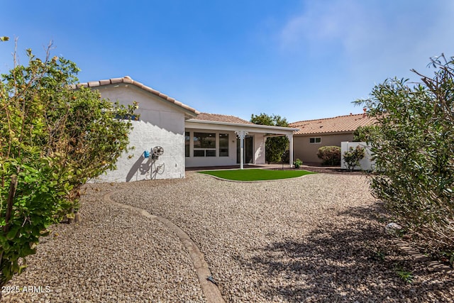 back of property featuring a patio area, a tile roof, and stucco siding