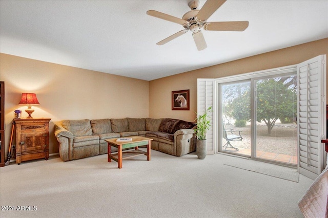 carpeted living room featuring ceiling fan