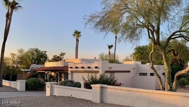 southwest-style home featuring a garage