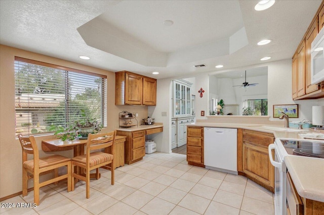 kitchen featuring a textured ceiling, white appliances, ceiling fan, sink, and light tile patterned floors