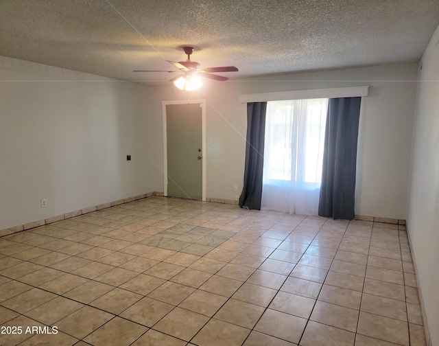 7525 W Turney Ave, Phoenix, AZ 85033 - spare room featuring a textured ceiling, ceiling fan, light tile patterned floors, and baseboards