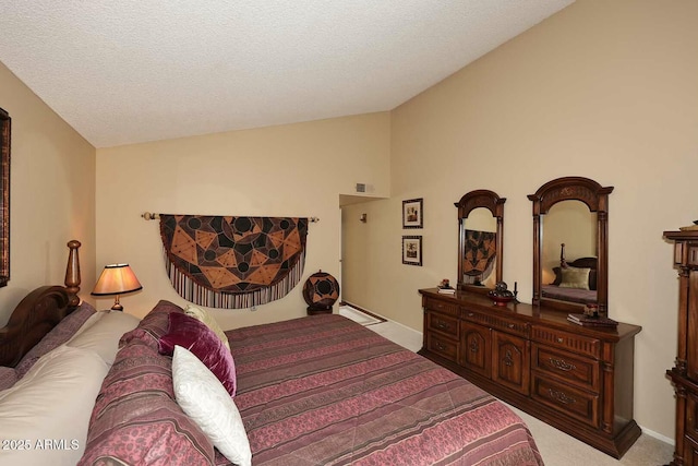 bedroom with visible vents, baseboards, lofted ceiling, carpet floors, and a textured ceiling