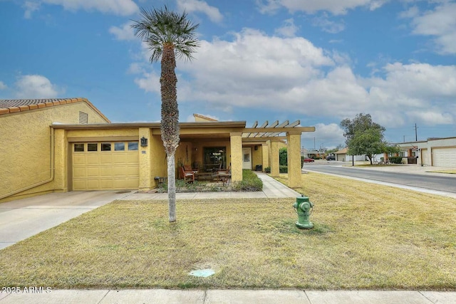 view of front of house with stucco siding, a pergola, concrete driveway, a front yard, and an attached garage