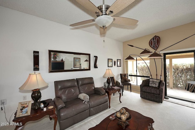 carpeted living area with a ceiling fan and a textured ceiling