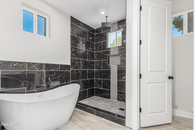 bathroom featuring independent shower and bath and tile patterned floors