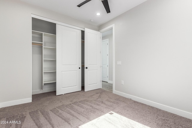 unfurnished bedroom featuring carpet flooring, ceiling fan, and a closet