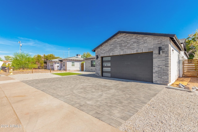 view of front of property featuring a garage and an outdoor structure