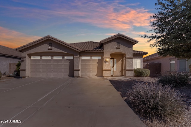 mediterranean / spanish-style home featuring a garage