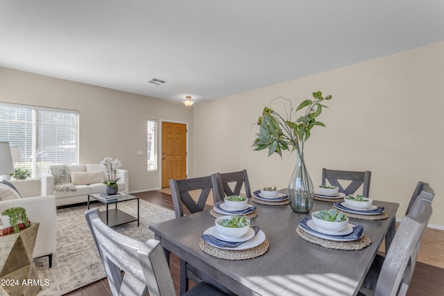 dining area with dark hardwood / wood-style flooring